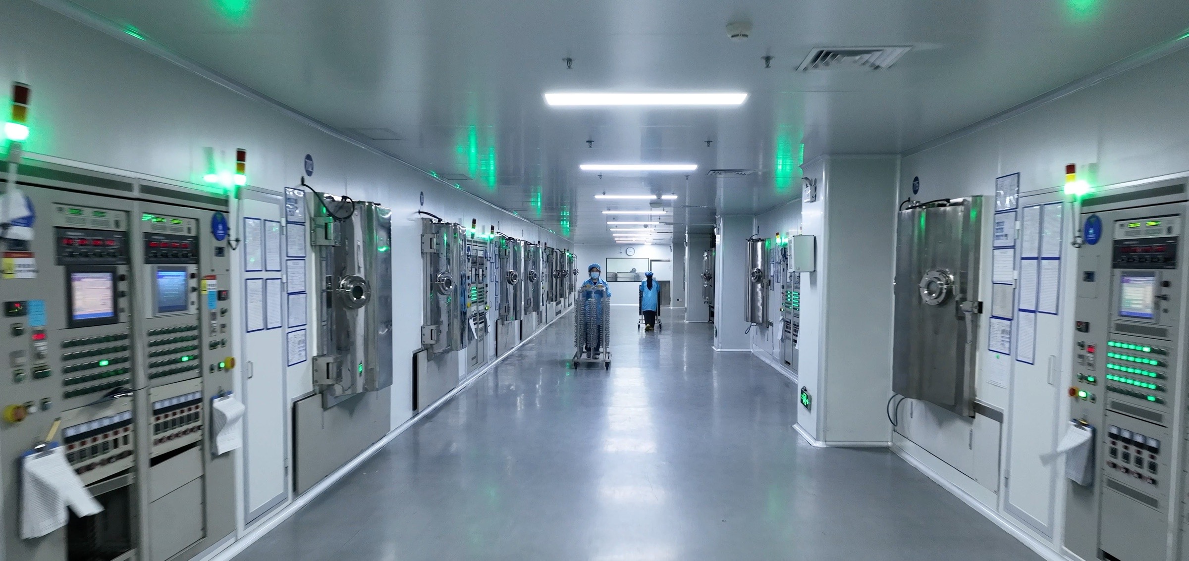 A row of PVD vacuum chambers in the Dongguan cleanroom