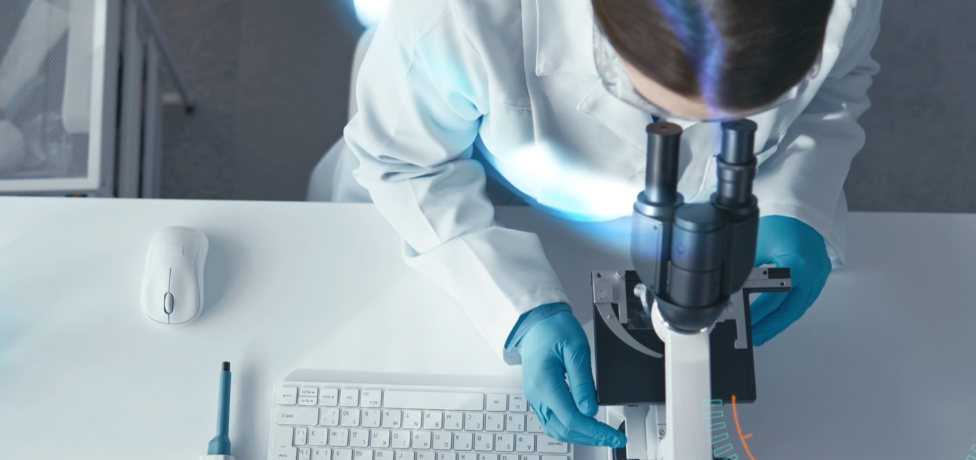 Engineer inspecting a coating under a microscope