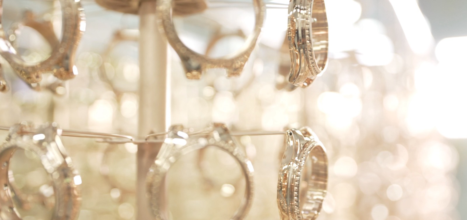 Rose gold watch cases on a plating rack