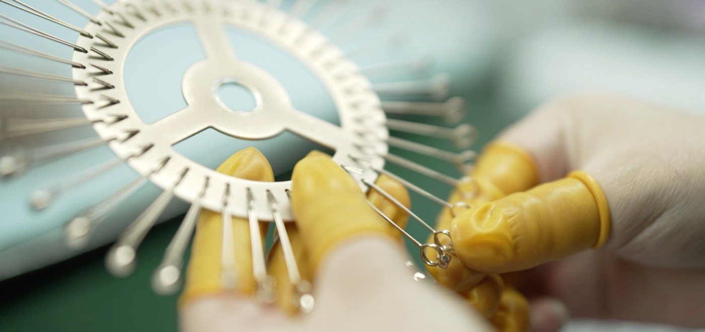 Watch bezels being mounted on a plating fixture